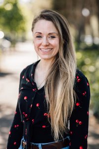 Blonde female content writer smiling at the camera